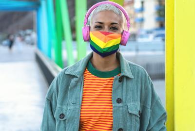 Person wearing a rainbow mask