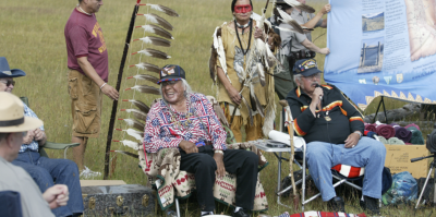 Nez Perce tribe members and NPS Rangers sit together during a commemoration of the Nez Perce Trail. (Photo/National Park Service)